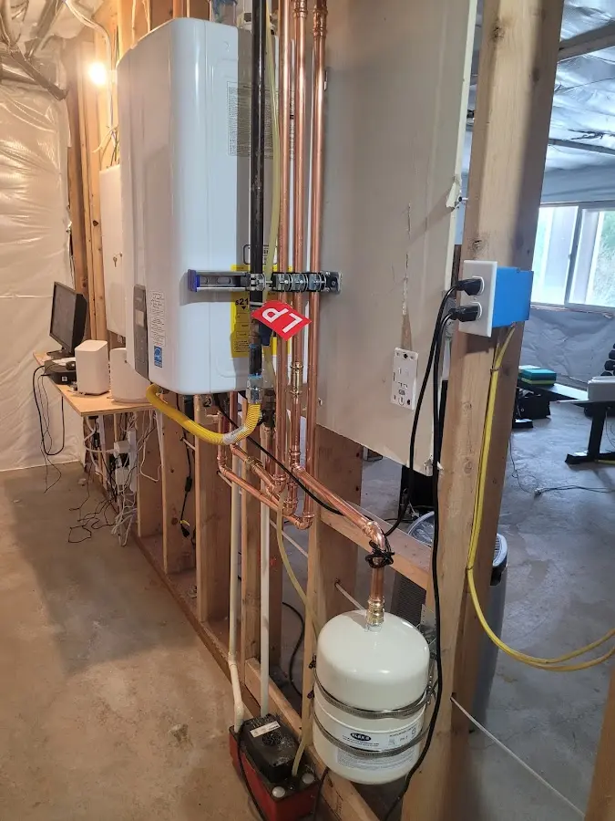 Licensed plumber repairing a kitchen sink in Kaser
